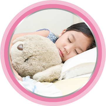 Girl sleeping with a baby doll.